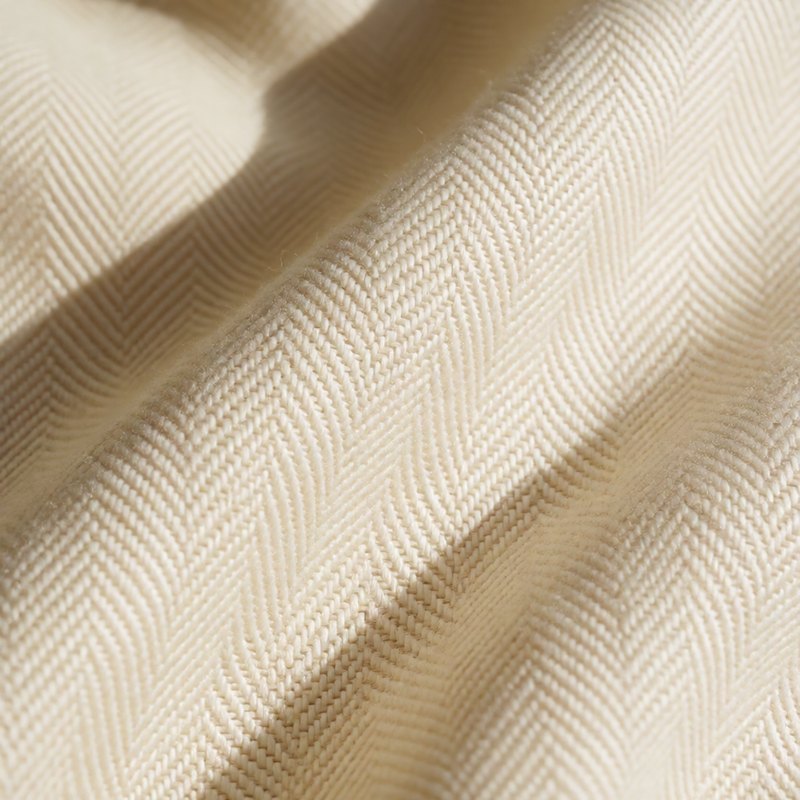Macro of ivory herringbone wool suiting fabric