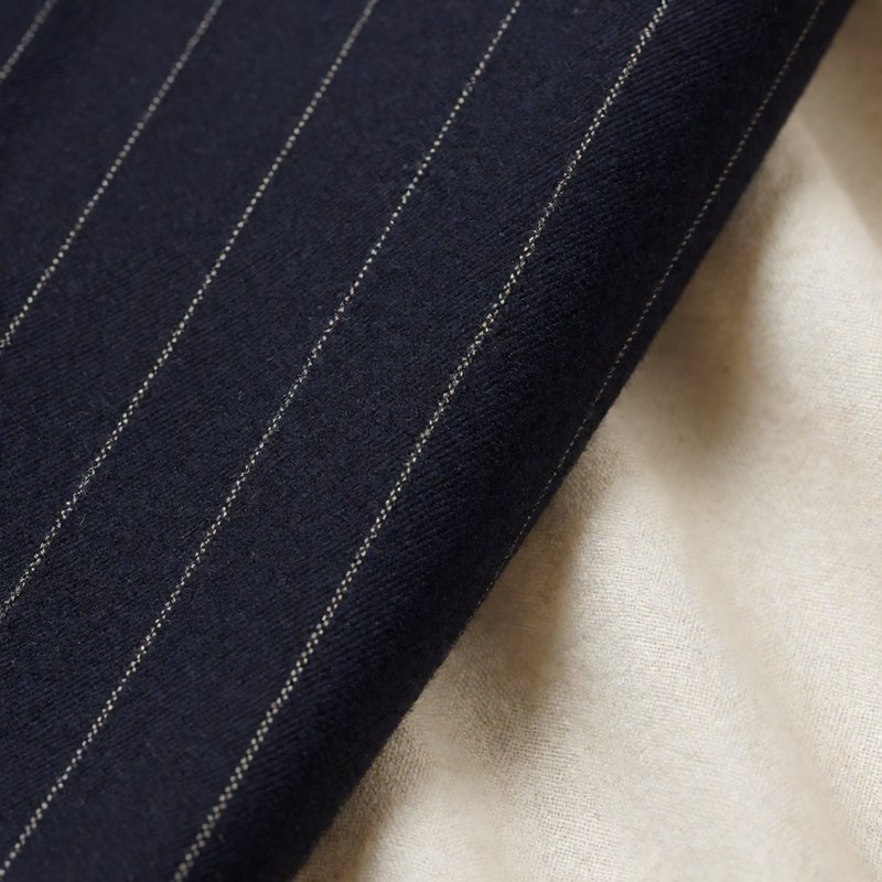 Macro of navy wool with fine champagne pinstripes