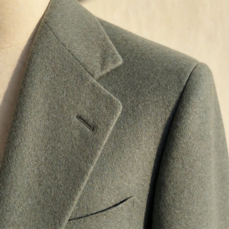 Close-up of the notch lapel curve and cashmere texture