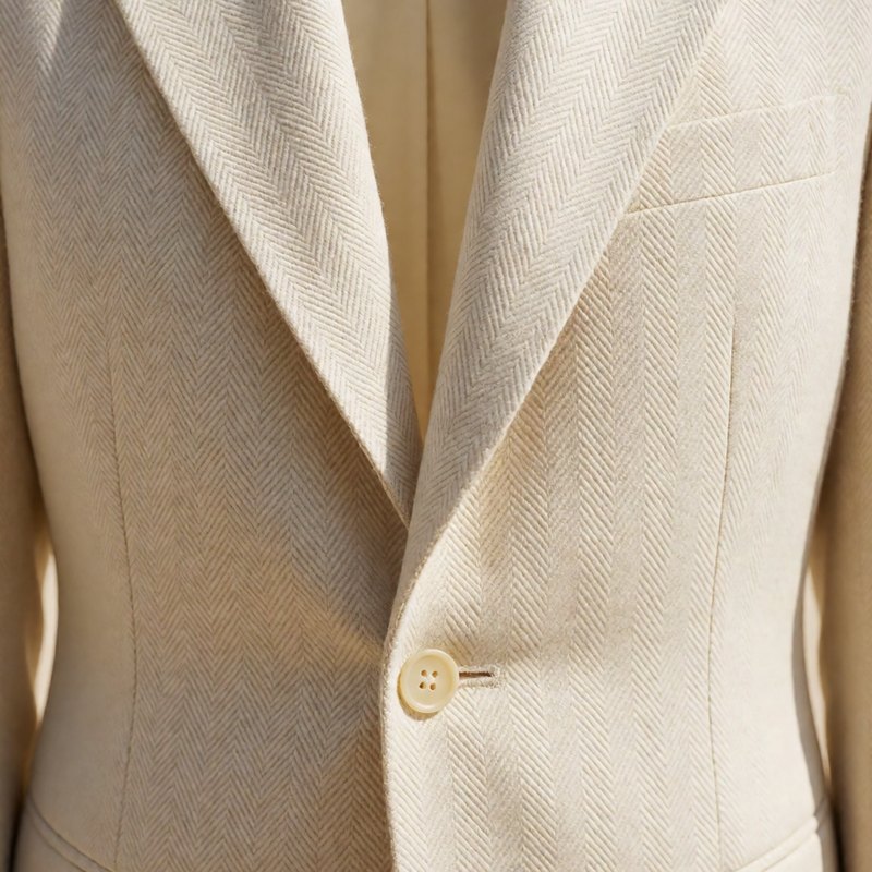 Close-up of the tone-on-tone herringbone weave at lapel and button