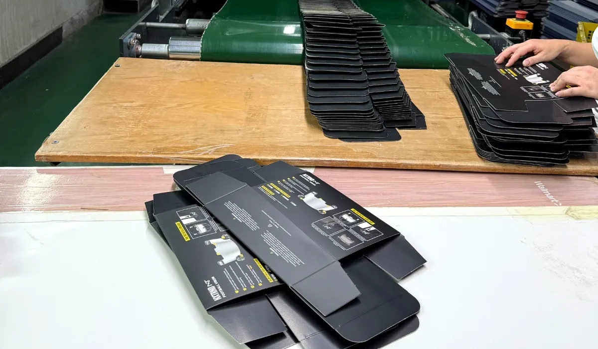 Printed folding carton blanks stacked and handled in a packaging factory