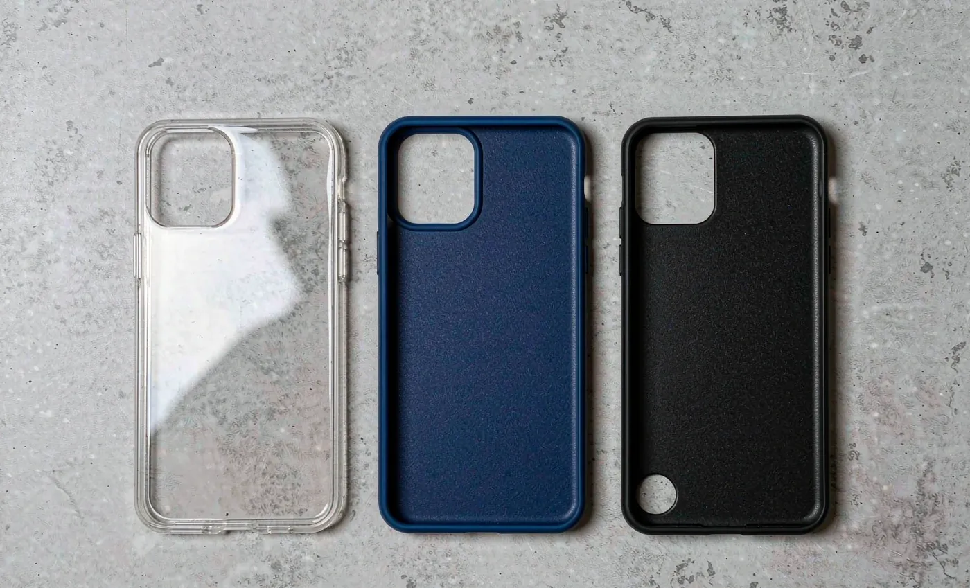 Three phone cases in glossy clear, matte blue silicone and black PC side by side