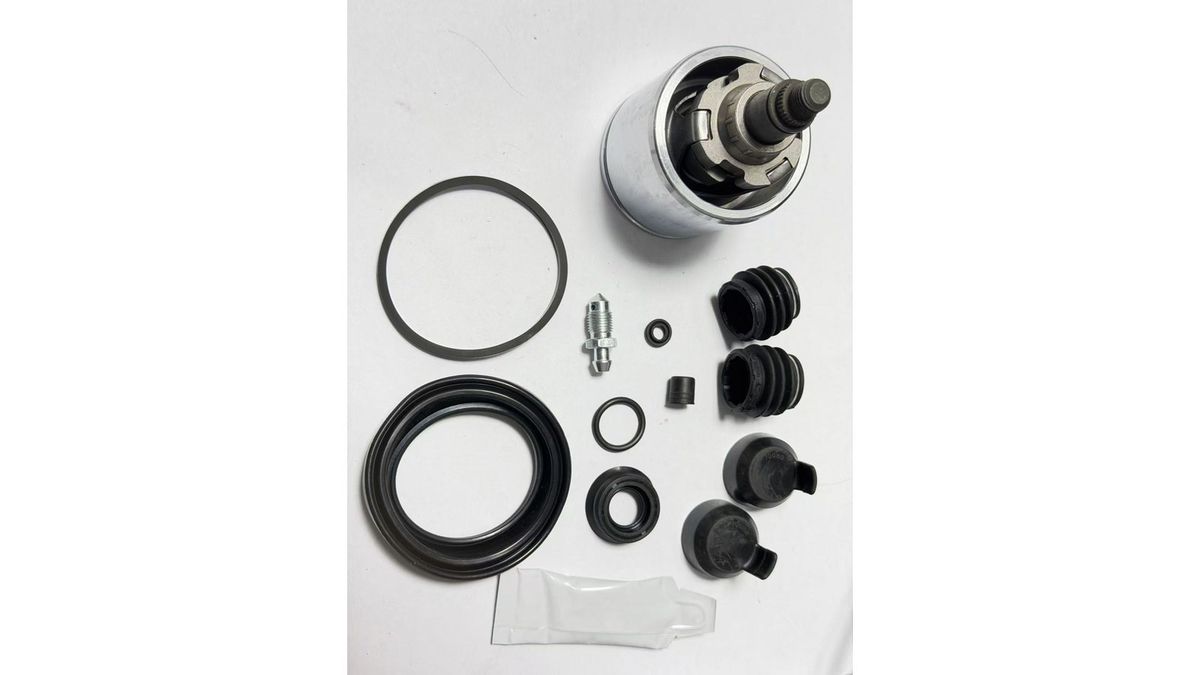 Brake caliper repair kit components laid out for inspection