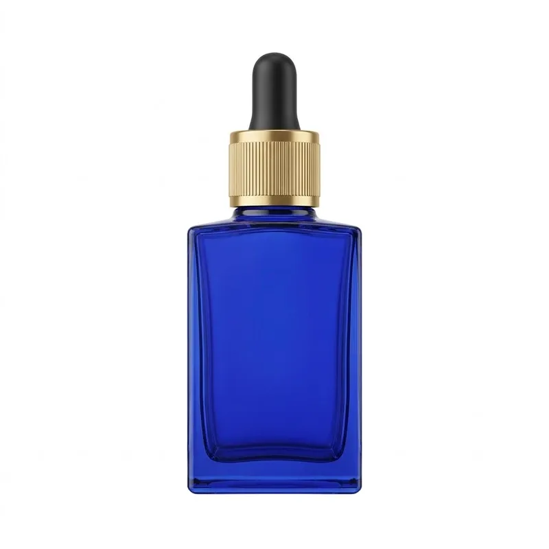 Cobalt blue flat-shoulder square glass dropper bottle with gold aluminum dropper cap on white background
