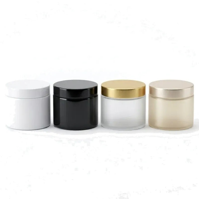 Four identical 300 ml mask jars in white, black, frosted glass with gold lid, and champagne frosted finishes