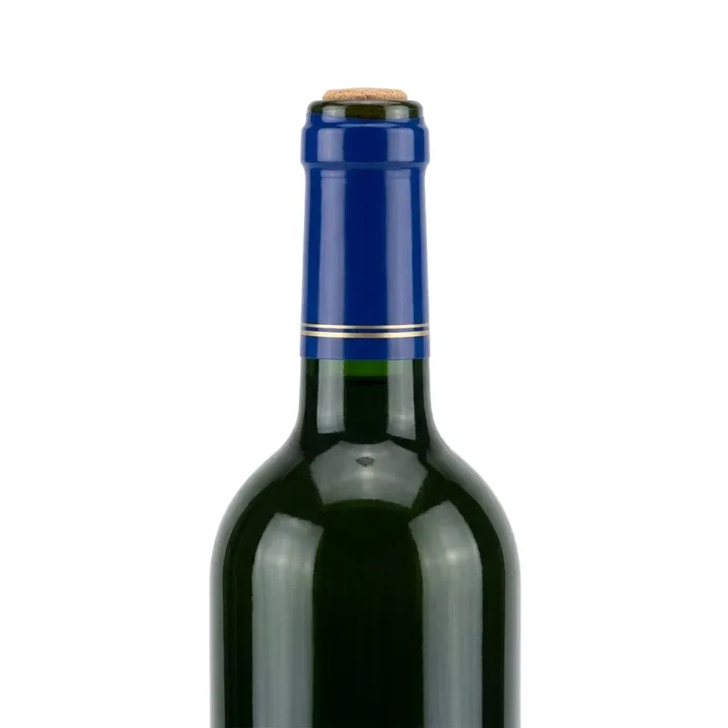 Blue PVC heat shrink capsule heat-shrunk onto a dark green glass wine bottle neck sealing the cork as a tamper evident seal
