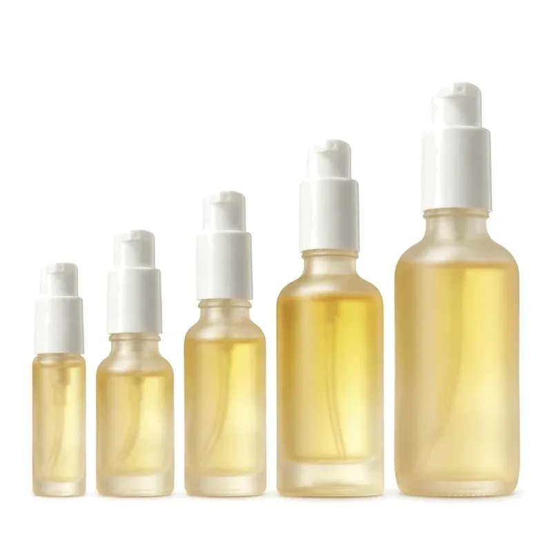 Five frosted glass spray bottles of increasing size with white fine-mist pumps, size family lineup