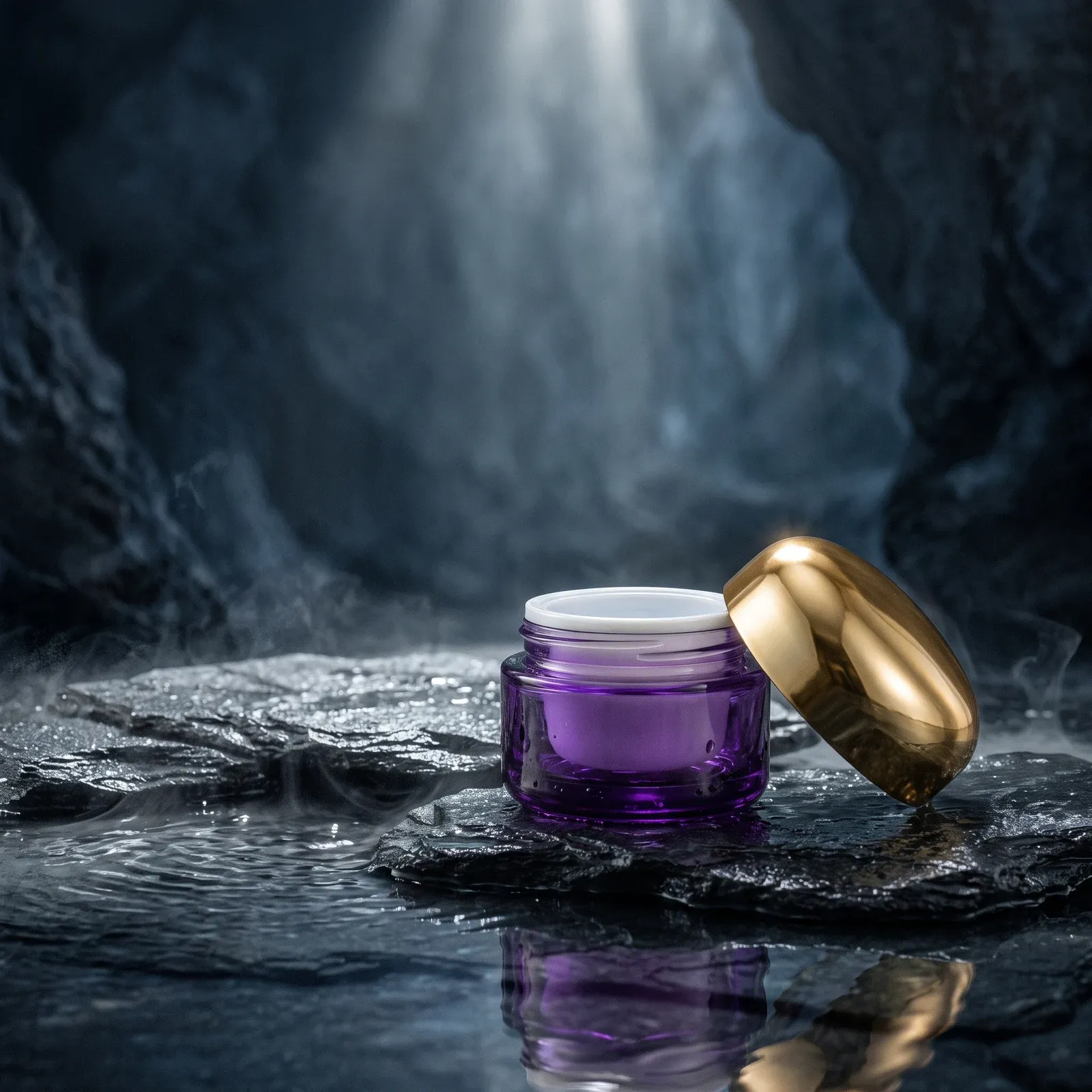 Open violet glass cream jar with white inner liner and its gold dome lid on wet slate rock