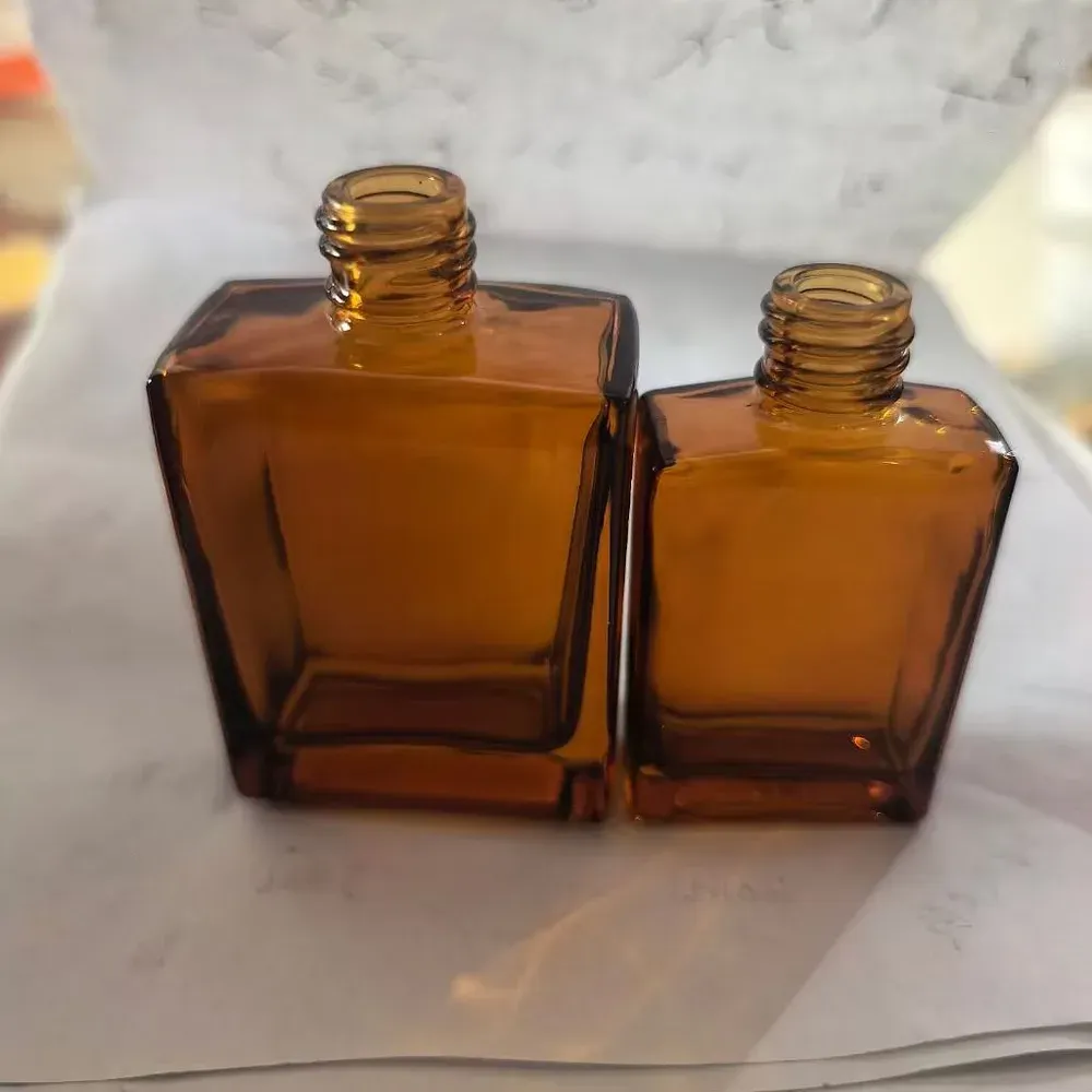 Two square amber glass bottles with exposed threaded glass screw necks