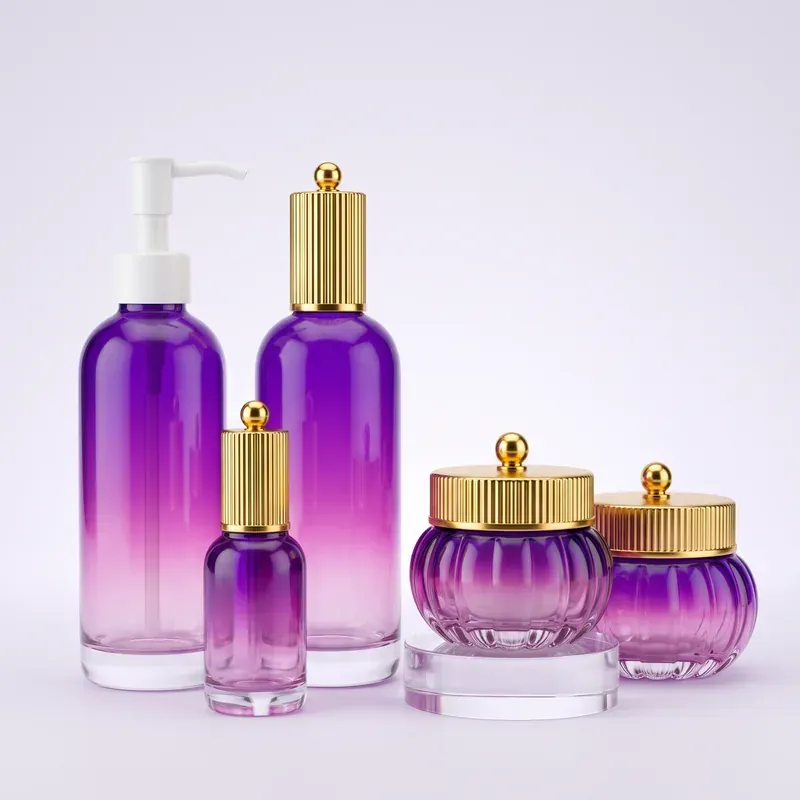 Purple gradient glass packaging set with two closure systems: white lotion pump bottle, gold fluted-cap serum bottles and pumpkin-ribbed cream jars