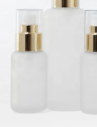 Frosted glass spray bottles in two sizes with gold collars