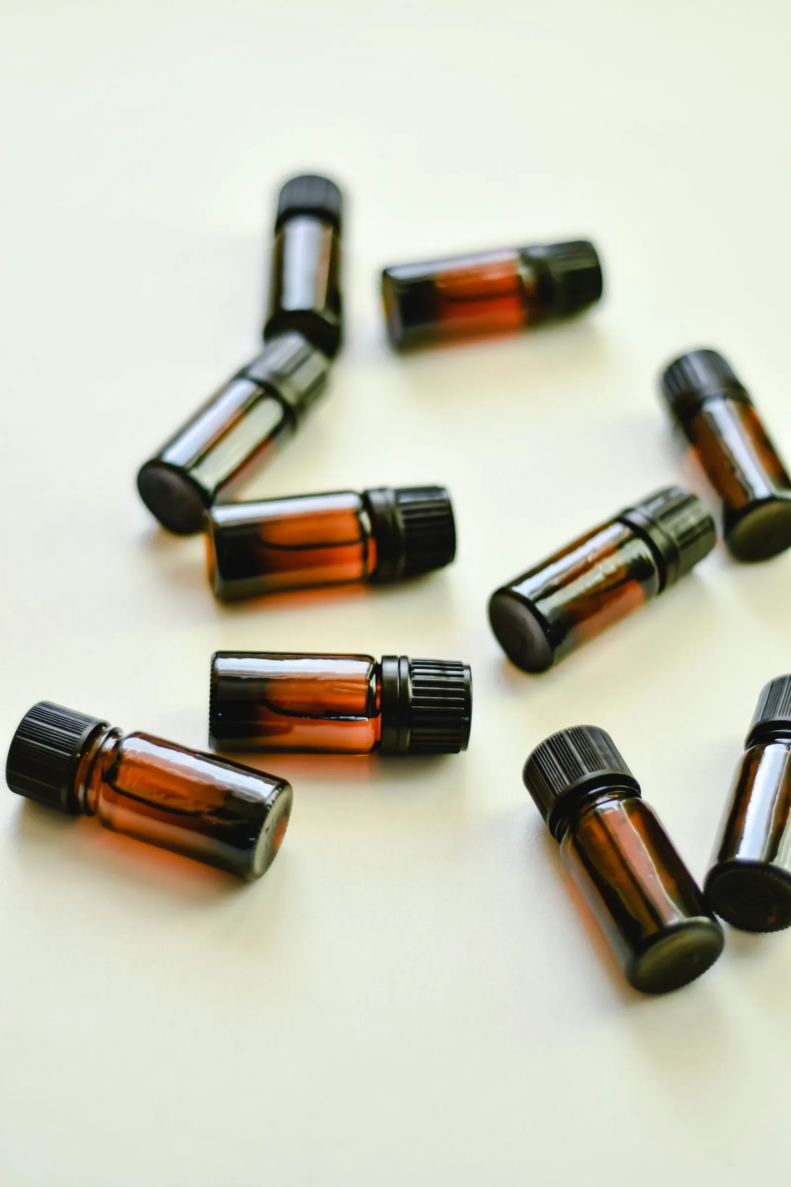 A variety of amber glass bottles laid out on a white background, sample set for packaging evaluation
