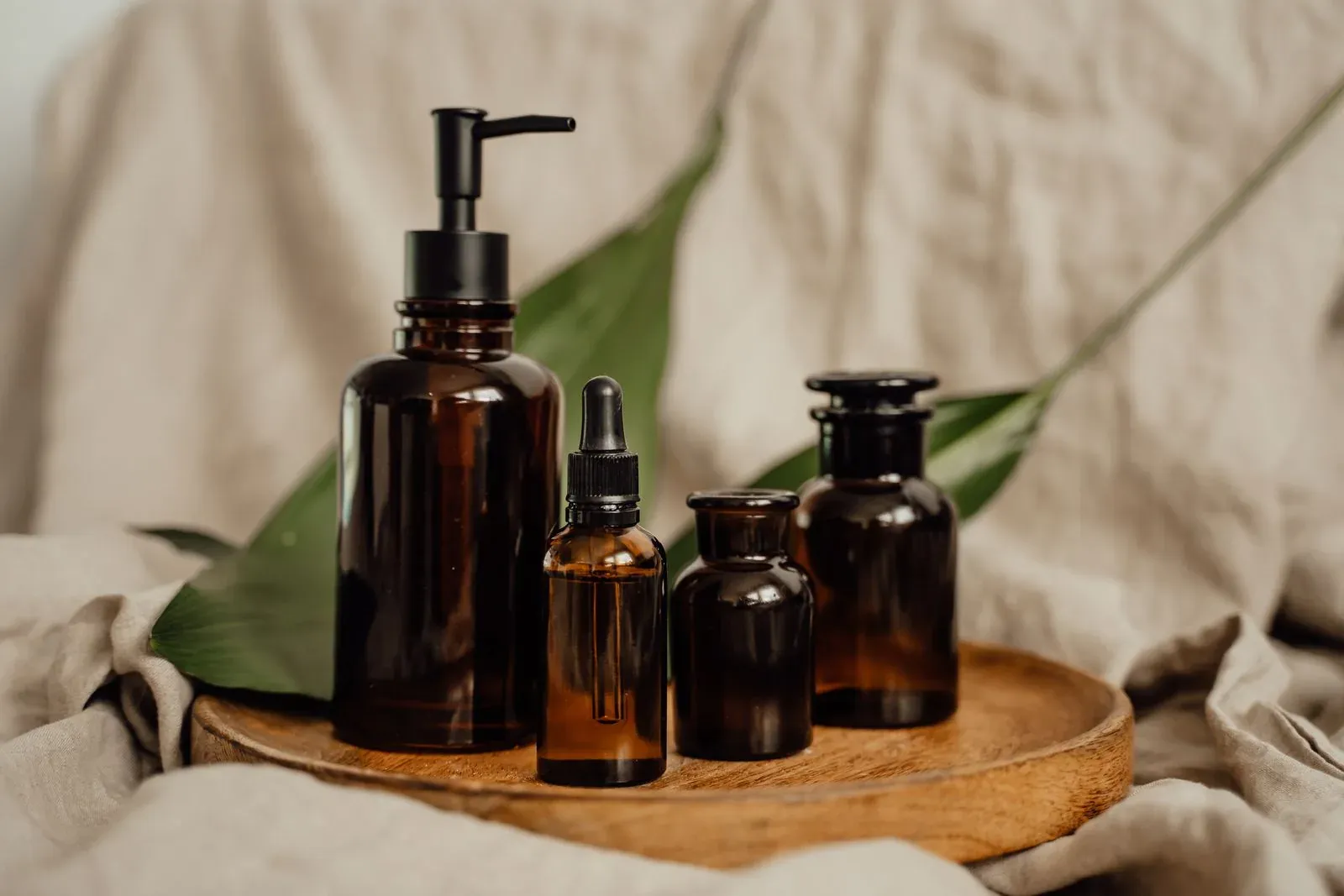 Amber glass bottles arranged on a wooden tray, a low minimum order starter set for a small brand
