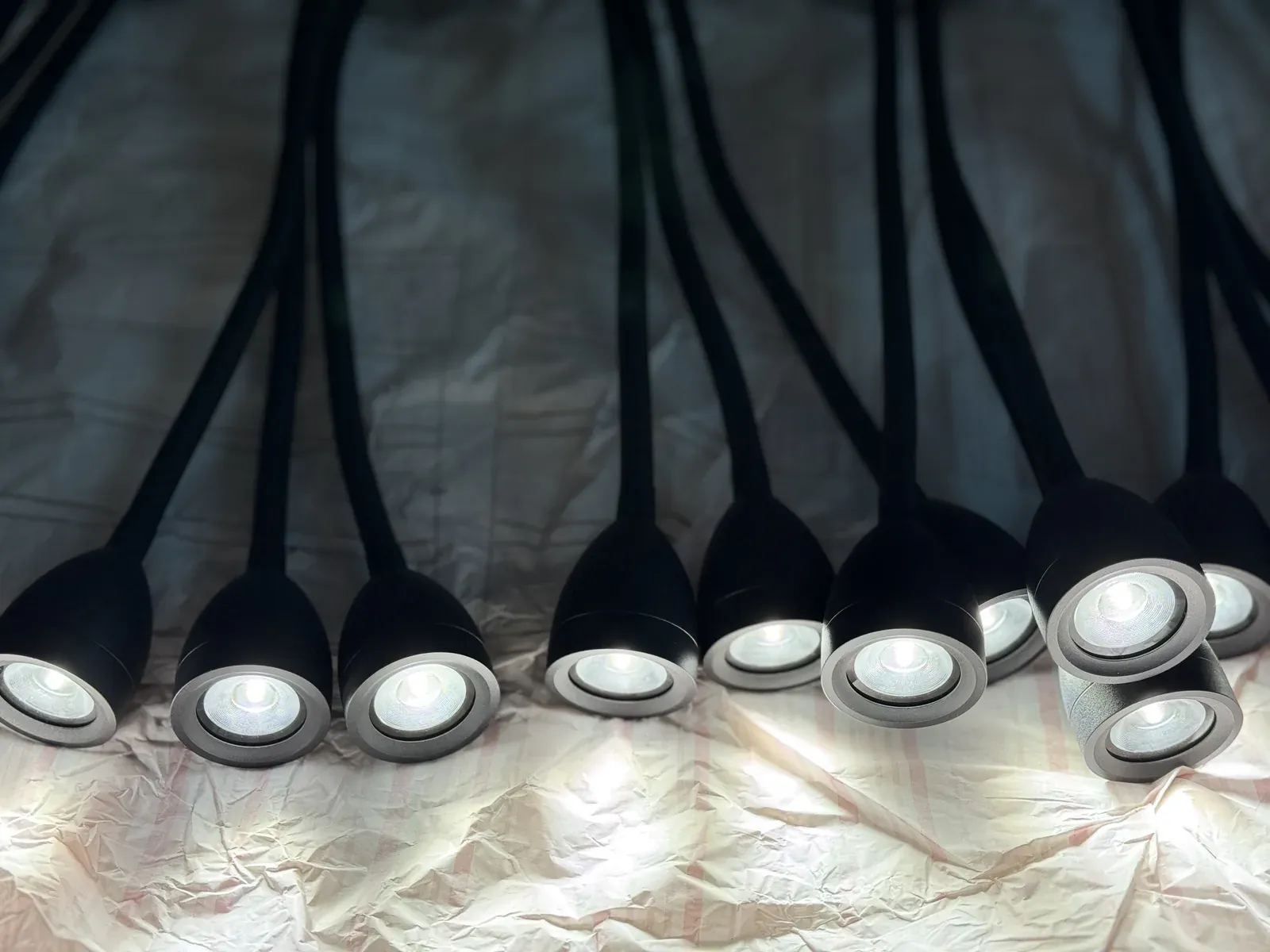 Rows of dark outdoor light heads in production at the workshop - NoorArch Lighting