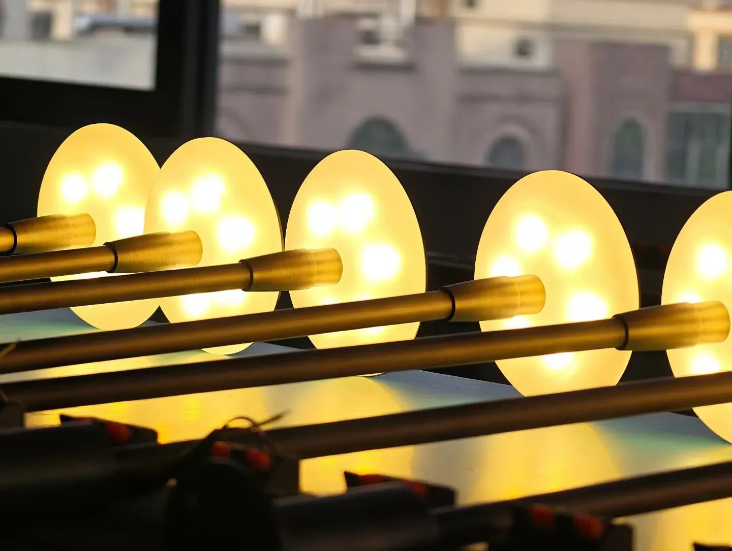 Brass linear garden lights glowing on the test rack - NoorArch Lighting
