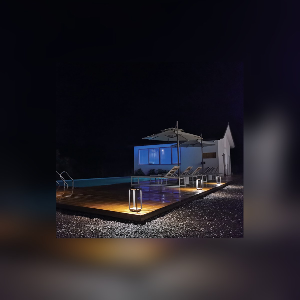 Handy series lanterns by a pool at night
