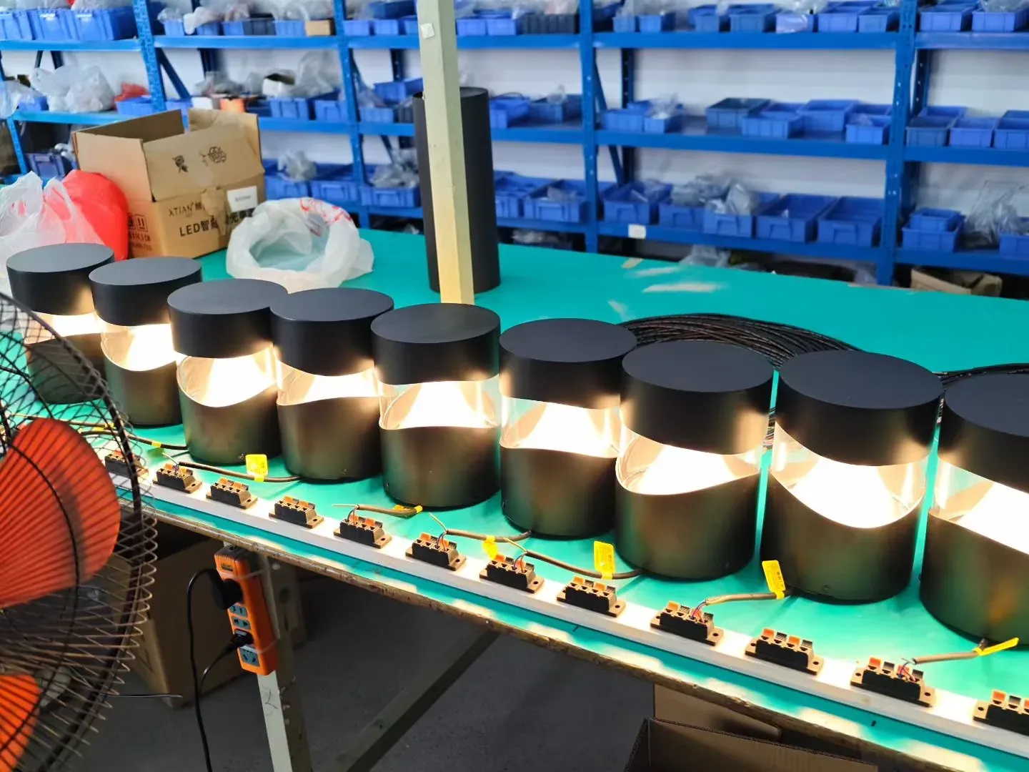 Outdoor garden lighting aging-test production line with lit bollard lights ready for export - NoorArch Lighting