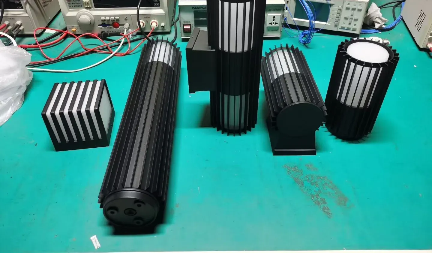 Ribbed aluminium outdoor wall lights and drivers on the electrical test bench - NoorArch Lighting