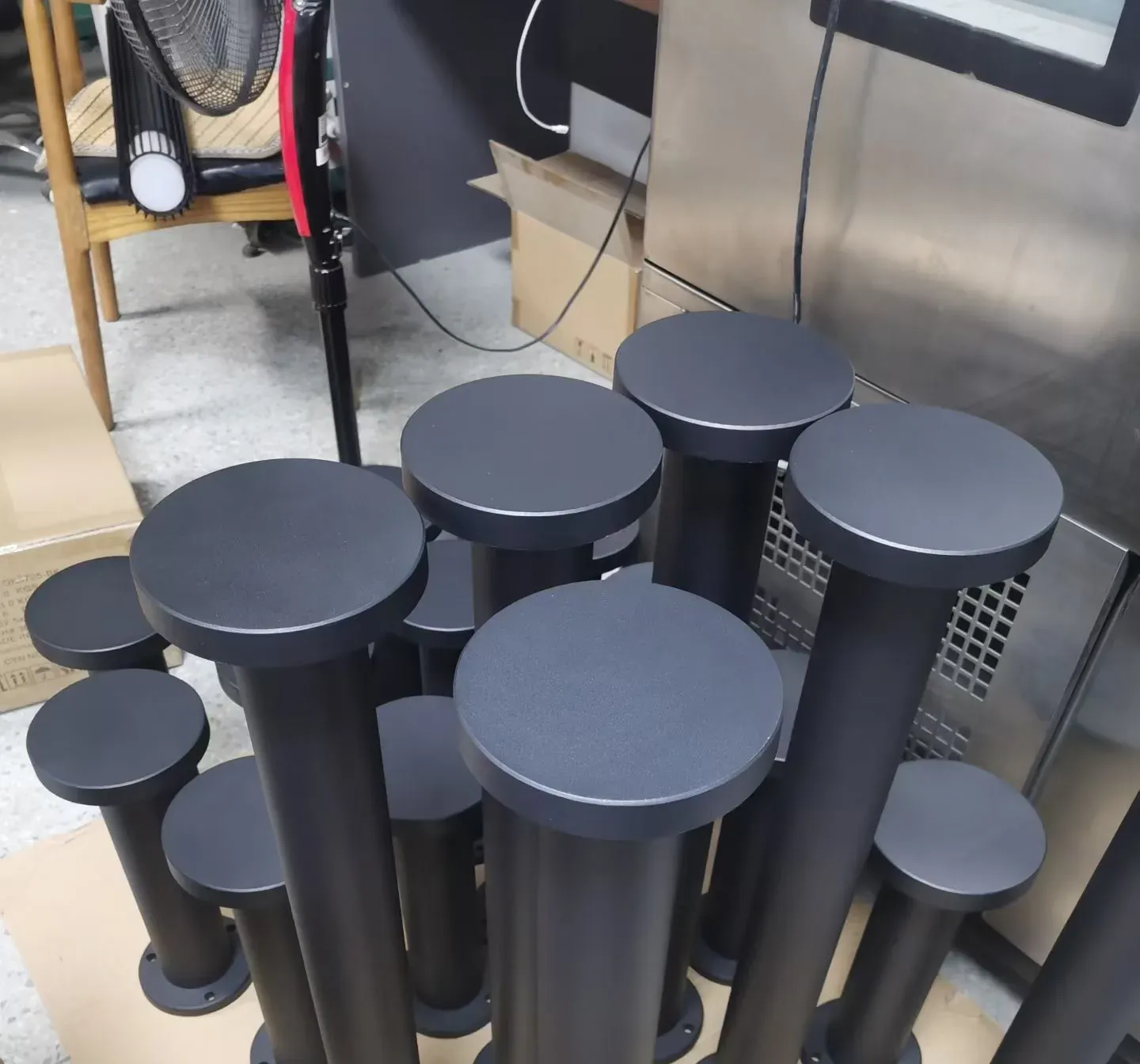 Batch of dark grey aluminium garden bollard lights in production - NoorArch Lighting