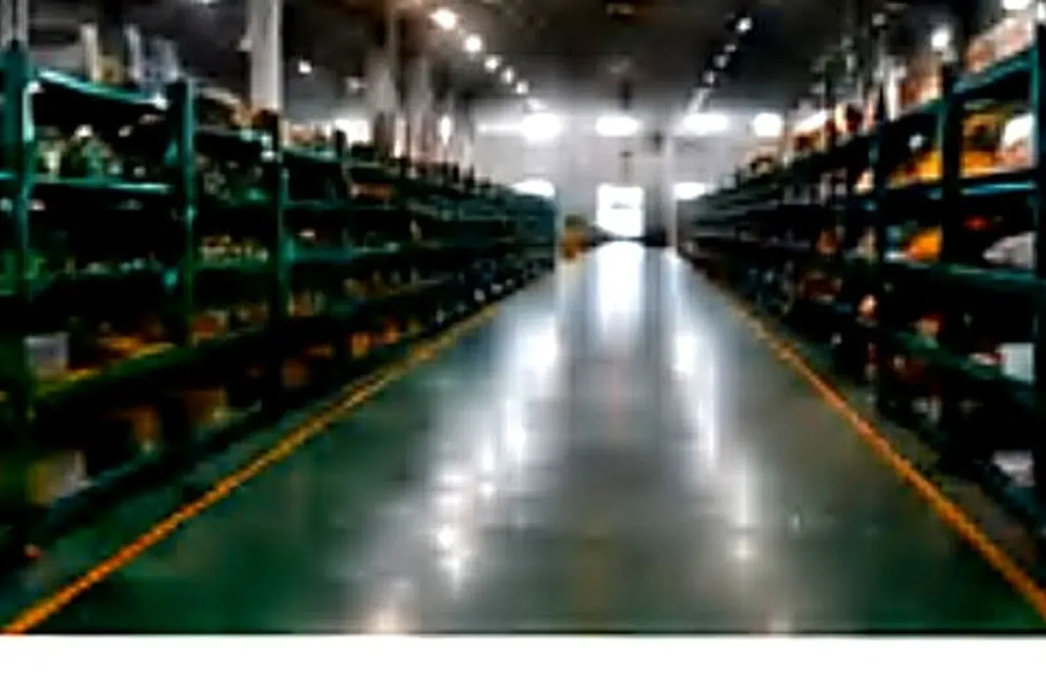 Nested stainless steel pots stacked on warehouse shelving.