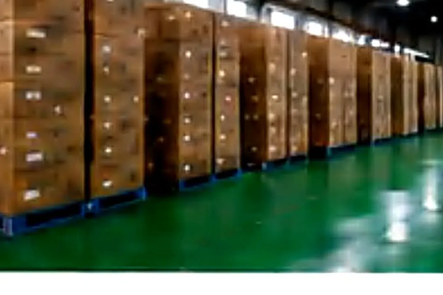 Cartons staged in the finished-goods warehouse before mixed-container loading.