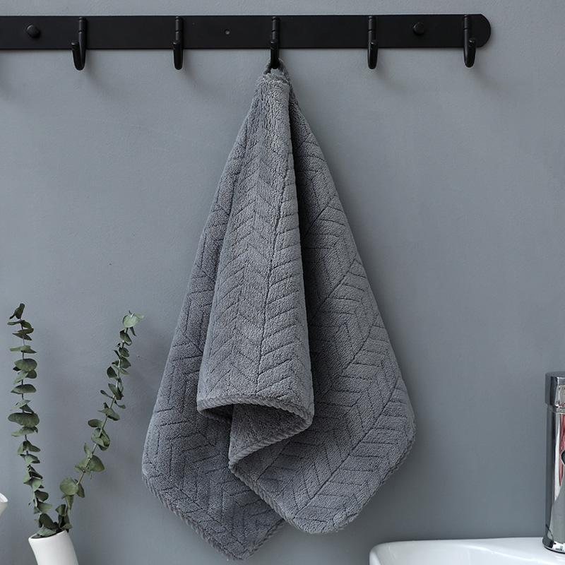Gray bath towel hanging on a rail, hotel bathroom setting