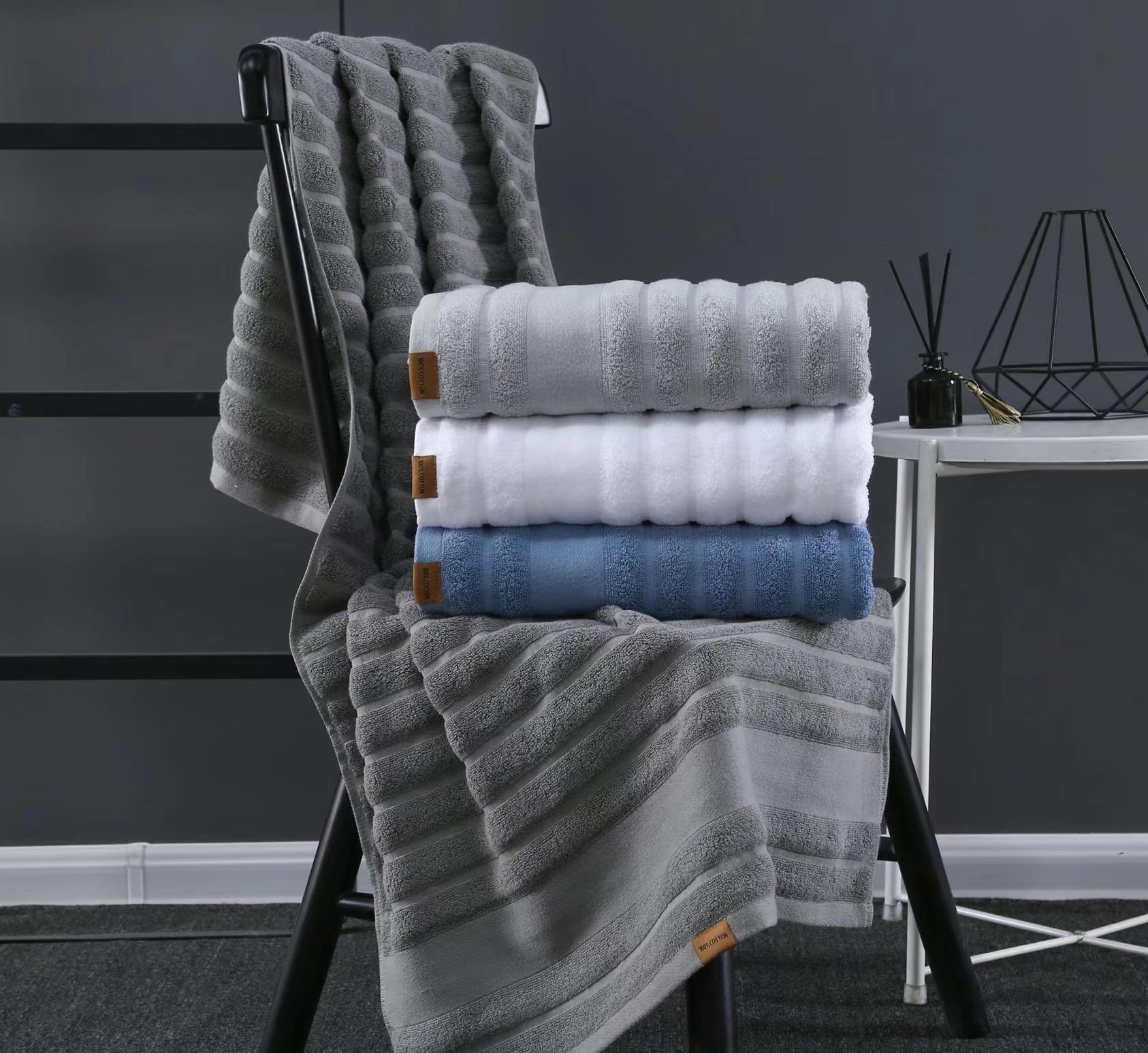 Folded microfiber towels stacked by size, showing fabric weight difference
