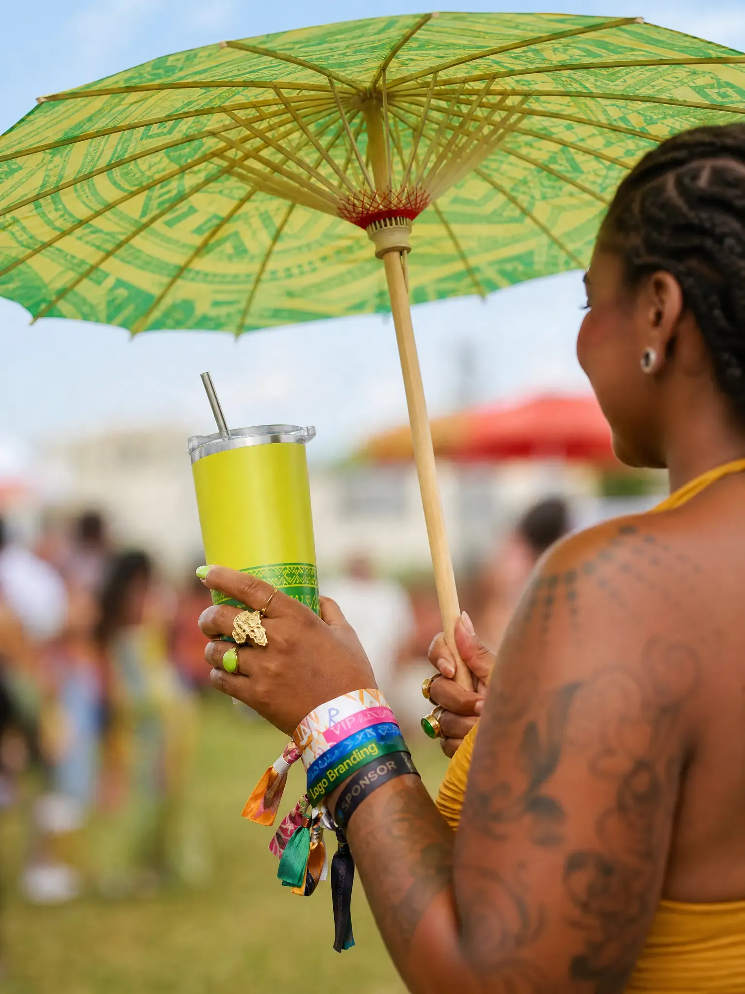 Custom event merchandise including tumbler wooden umbrella wristbands and outdoor party products