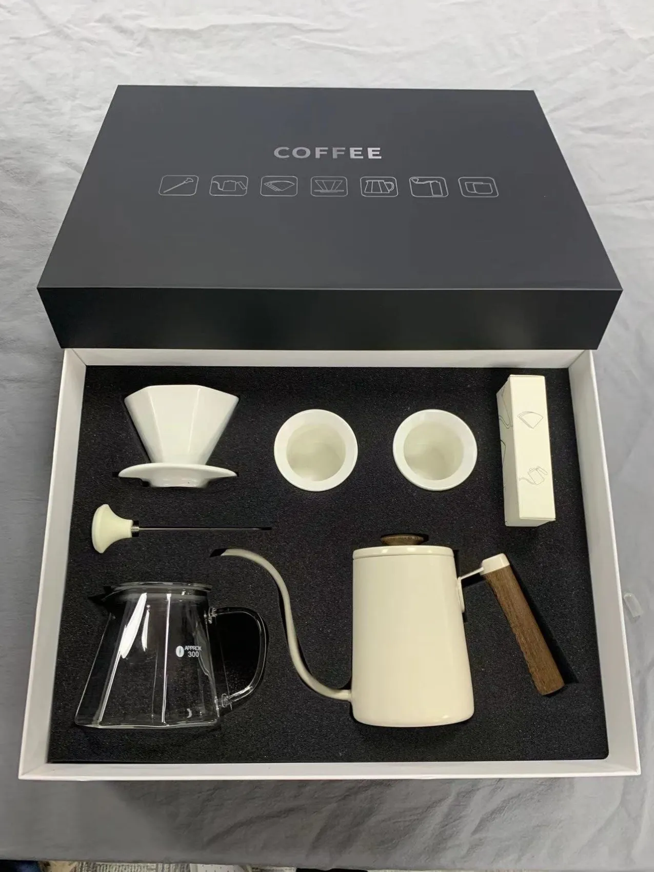 White coffee gift set unboxed - ceramic dripper, cups, glass server and kettle in foam insert